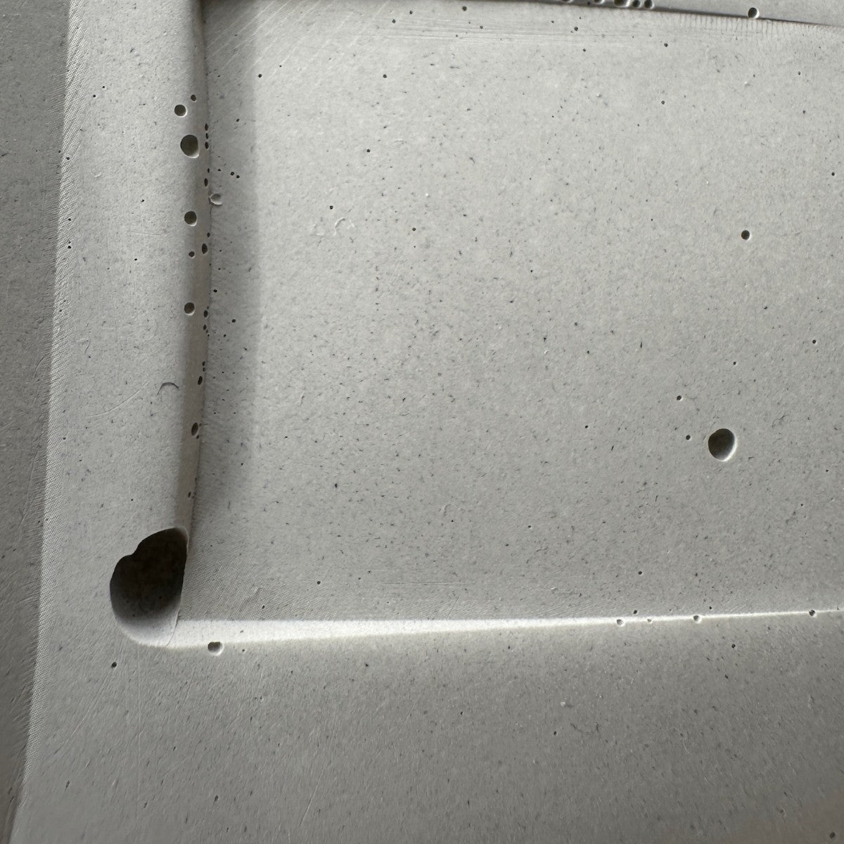 Air bubbles caught along a casting line on a Naturally Imperfect concrete model